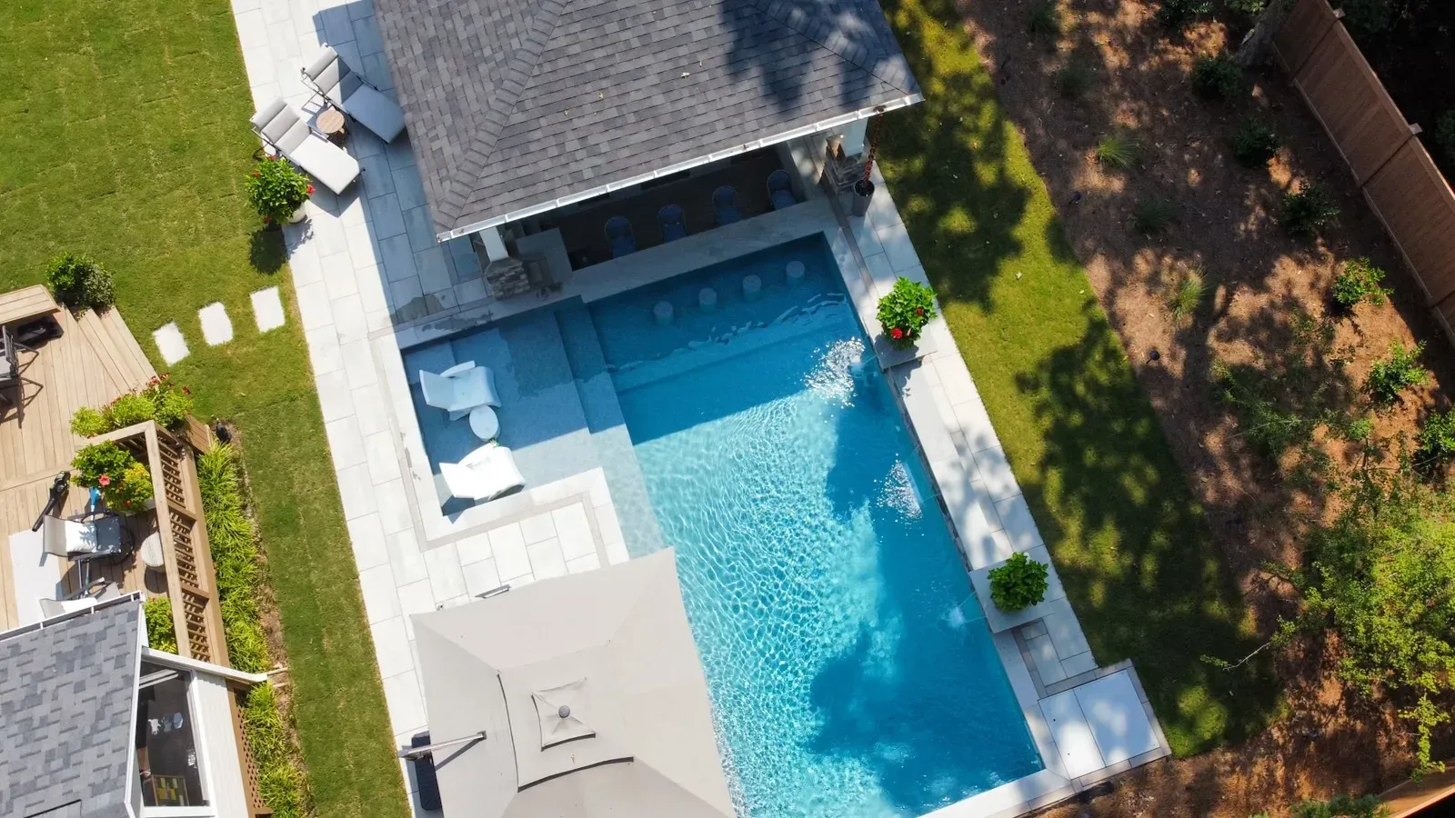 Cary Inground Pool, Granite Grey Membrane with Techo Bloc Blu Grande Pavers and Oversized Poolside Pavilion with Swim-Up Bar