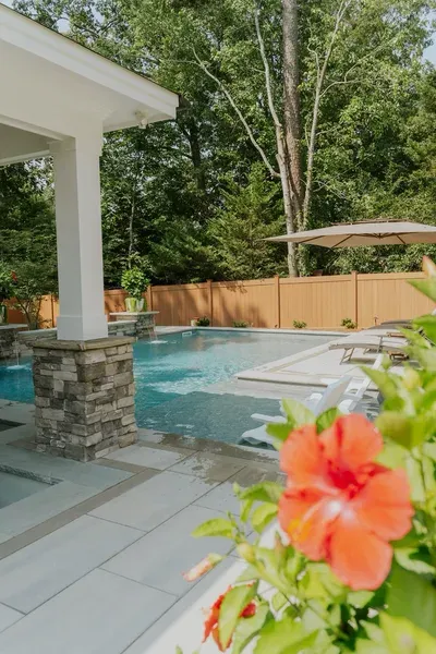 Poolside lounge area built by NOAT Outdoor Living